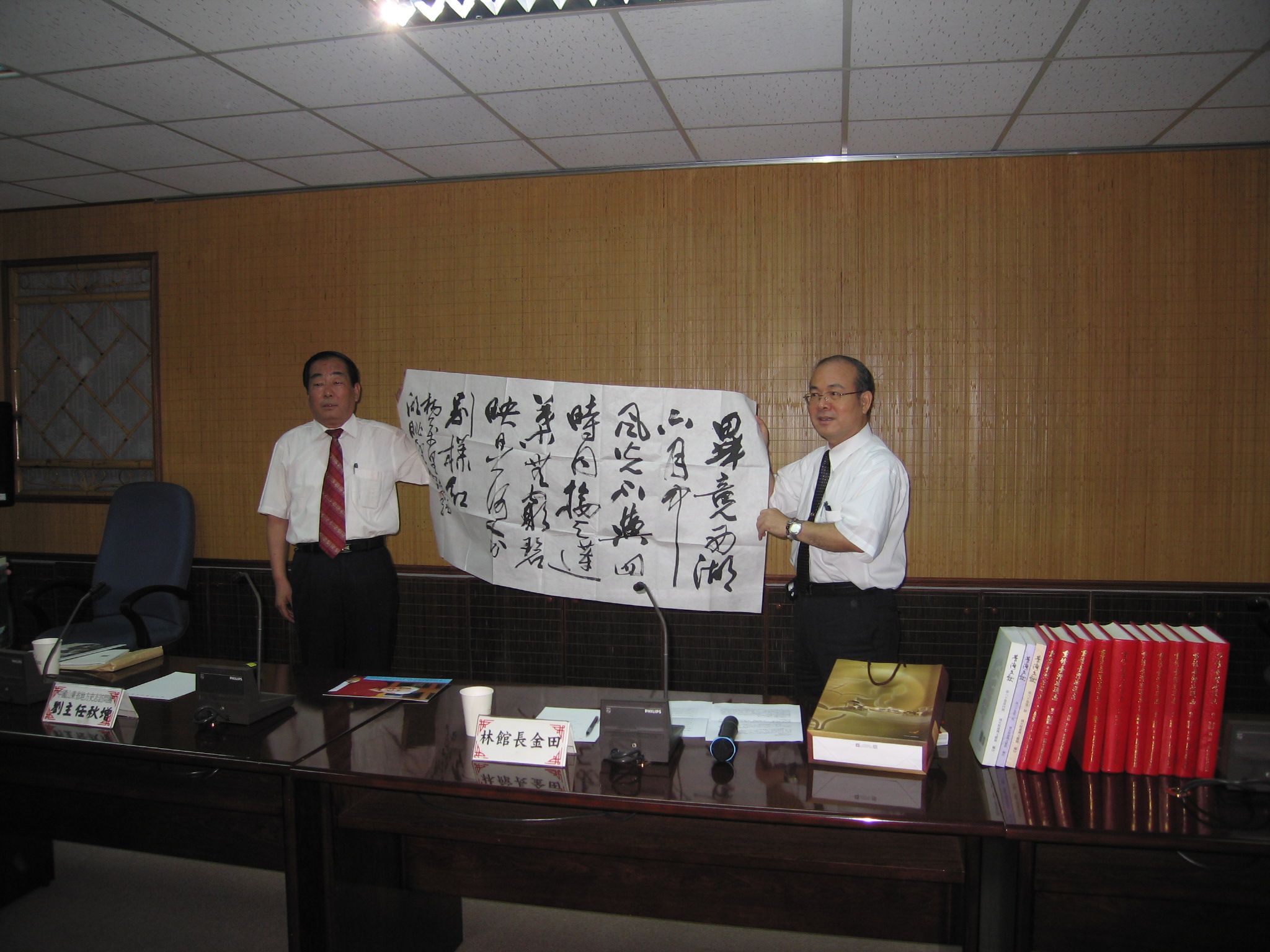 本館林館長金田(右)接受山東省地方史志辦公室劉主任秋增(左)致贈本館紀念品