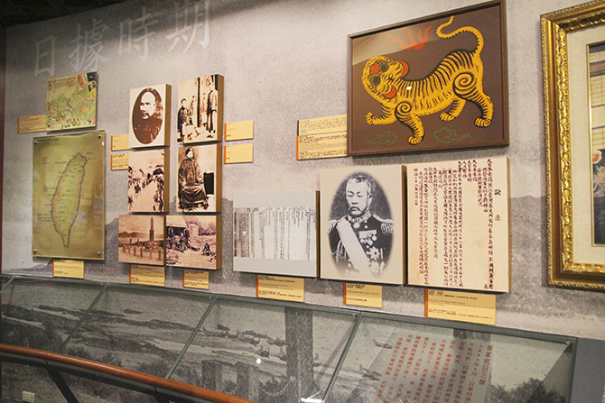 There is a flag on the wall. It was the flag of the Republic of Formosa. It was a short-lived republic that existed on the island of Taiwan in 1895.