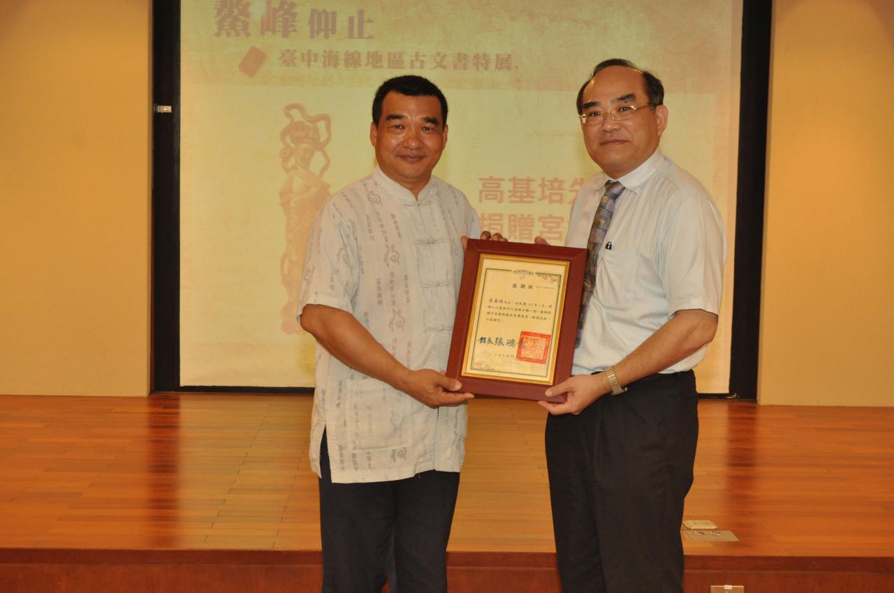 開幕式圖12：張鴻銘館長(右)致贈感謝狀予文物捐贈人高基培先生(左)